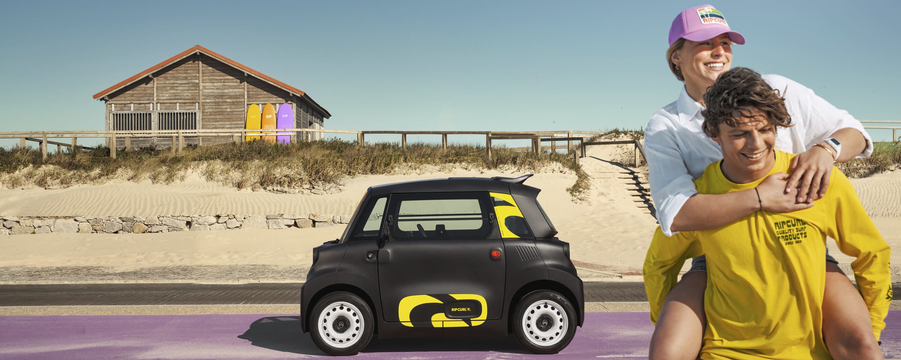 Side lifestyle view Citroën Ami x Rip Curl Elektrofahrzeug ohne Führerschein, Citroën Ami seaside freedom für urbane Elektromobilität