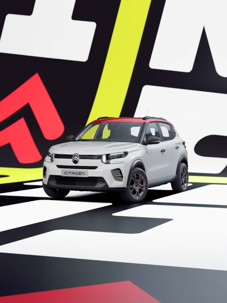 Dreiviertelansicht von vorne des Citroën ë-C3 TONIC Limited Edition Elektro-Stadtauto mit dynamischer Haltung und grafischer Inszenierung, smarte E-Fahrzeug Alternative